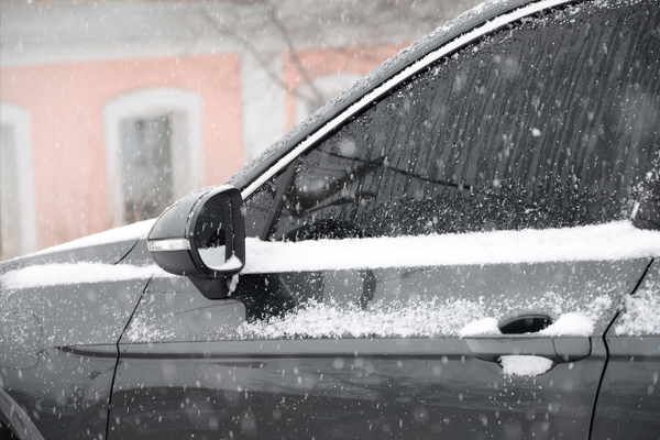 Black car parked during snowfall